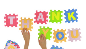 Hands forming words "Thank you" with jigsaw puzzle pieces isolated