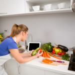 Woman in kitchen using tablet