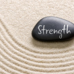 Black stone with the inscription Strength